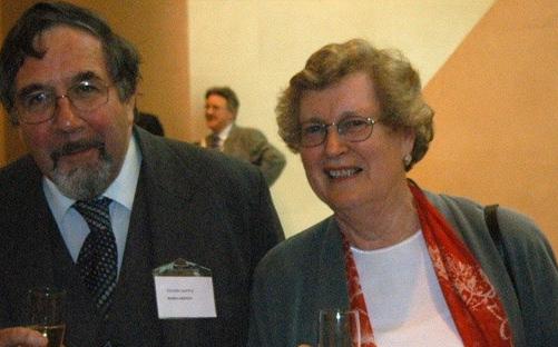 2 women and 2 men - Jill, Robin, Pat and Roger - standing in a row holding champagne glasses. They are standing in a large hall and behind them are other attendees at the event.